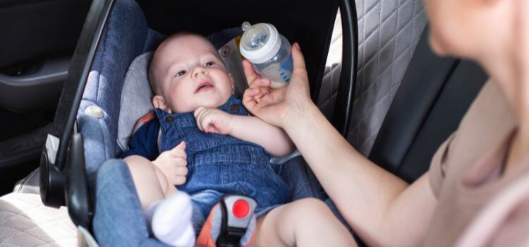 bottle-feed the baby in a car seat